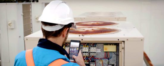 This photo shows a field worker using the HP Elite x3 device for his electrical audits