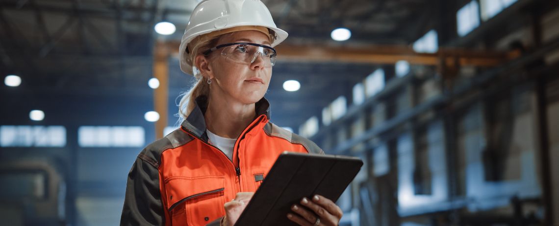 Female construction worker using a tablet to perform inspections
